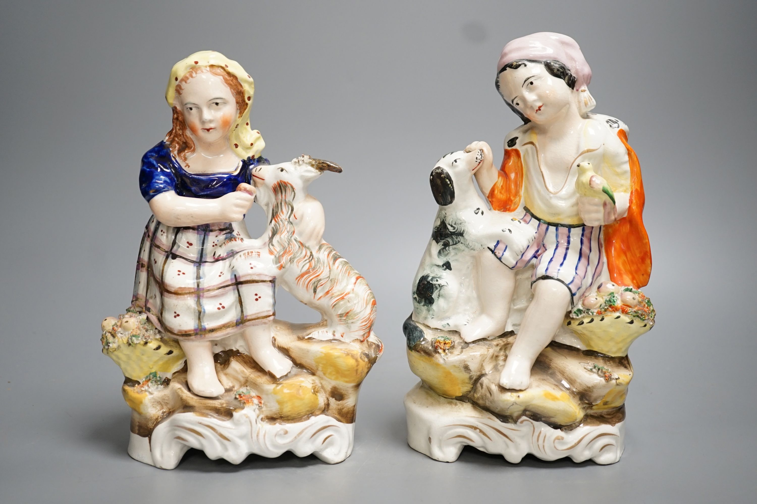 A pair of Victorian Staffordshire child and animal groups - tallest 23.5cm